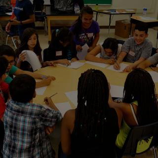 Students sitting around a desk