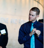 Two people standing listening 