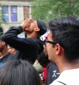 Student speaking to a large group outside