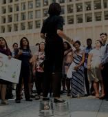 A student stands giving a speech in public