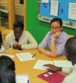 A student and teacher at a table 