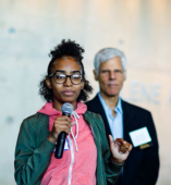 Student speaking with adult behind them