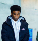 Student standing and listening