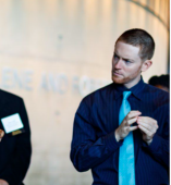 Two people standing listening 