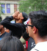 Student speaking to a large group outside