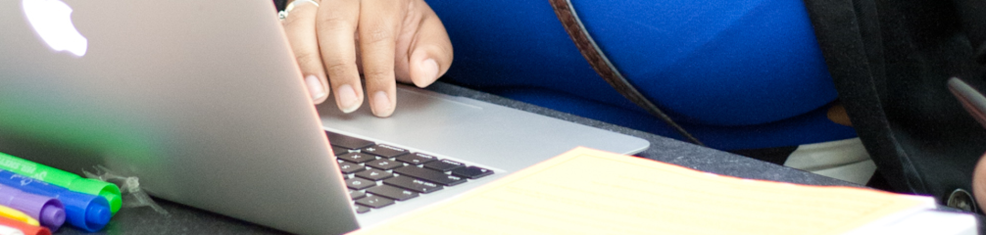 Student is typing on a laptop