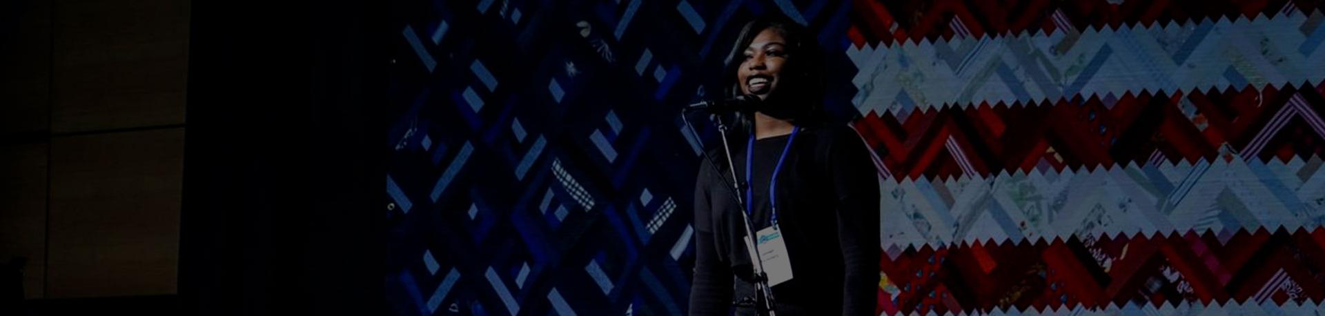 student in front of flag